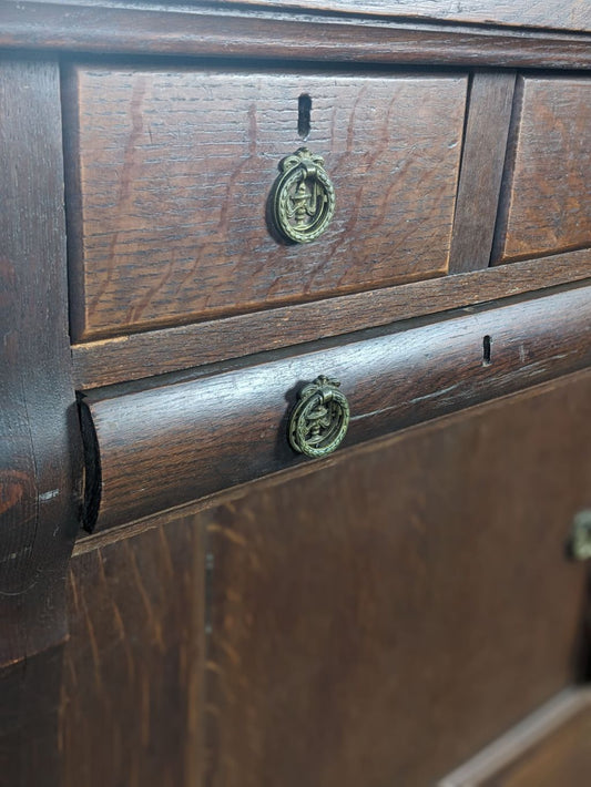 Close-up of antique dresser hardware and aged wood finish
