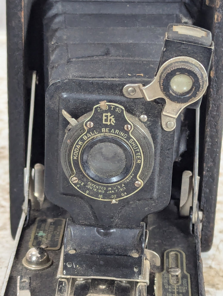 Retro camera gear with vintage film camera, classic lenses, flash and tripod accessories