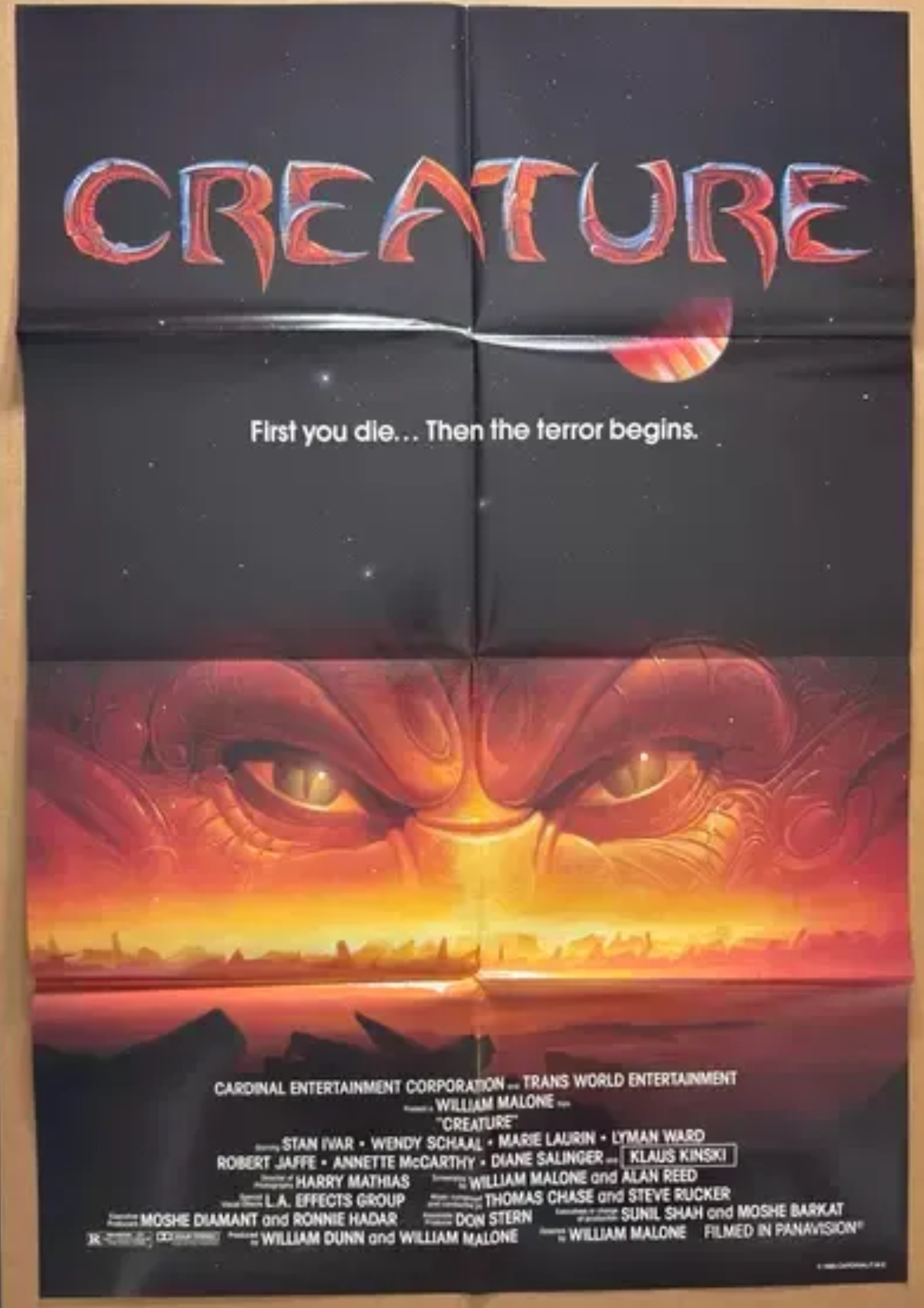 Movie poster for 'Creature' with a dark background and creature's eyes.