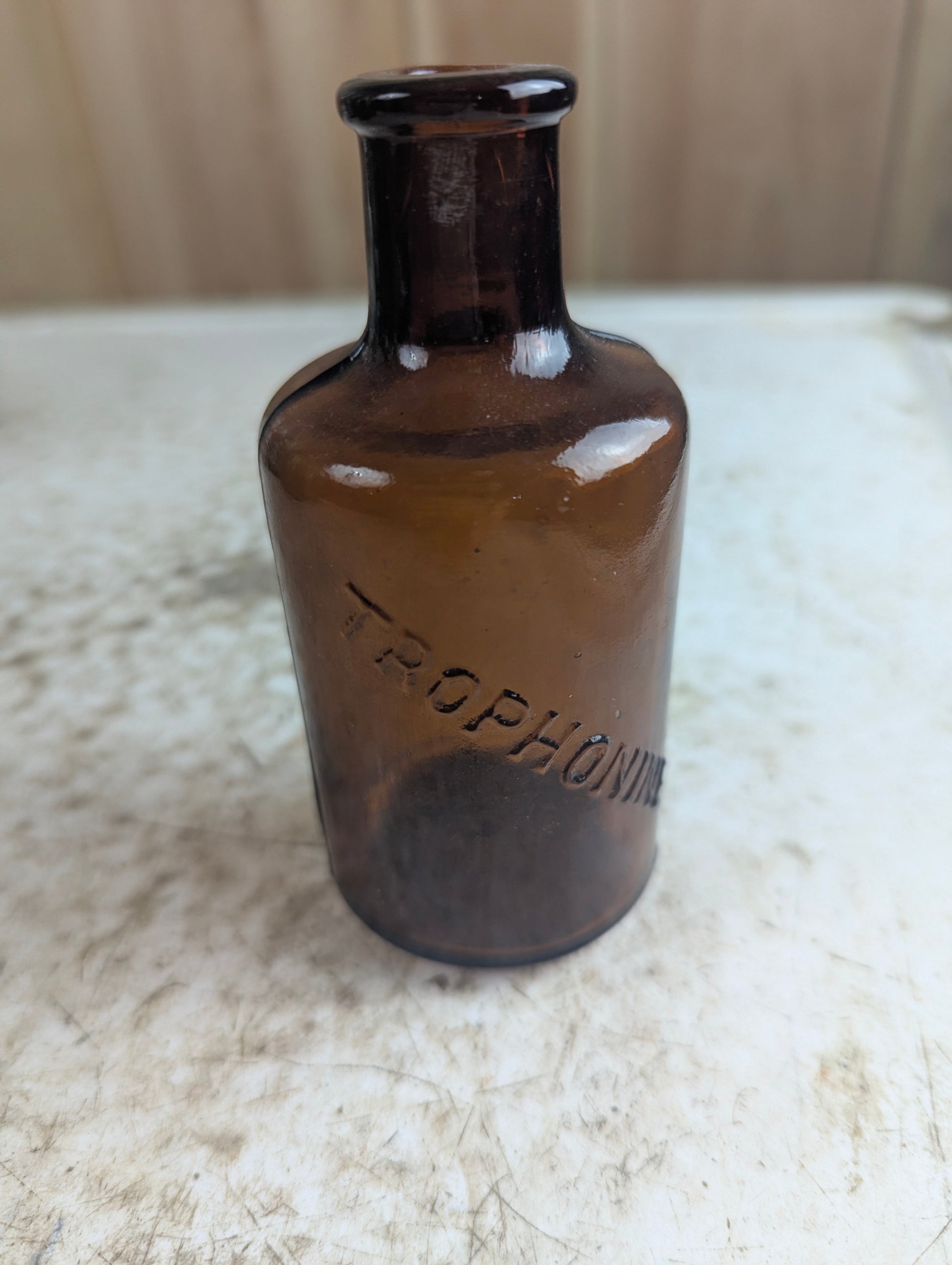 Antique Trophonine Reed & Carnrick Embossed Amber Glass Patent Medicine Bottle