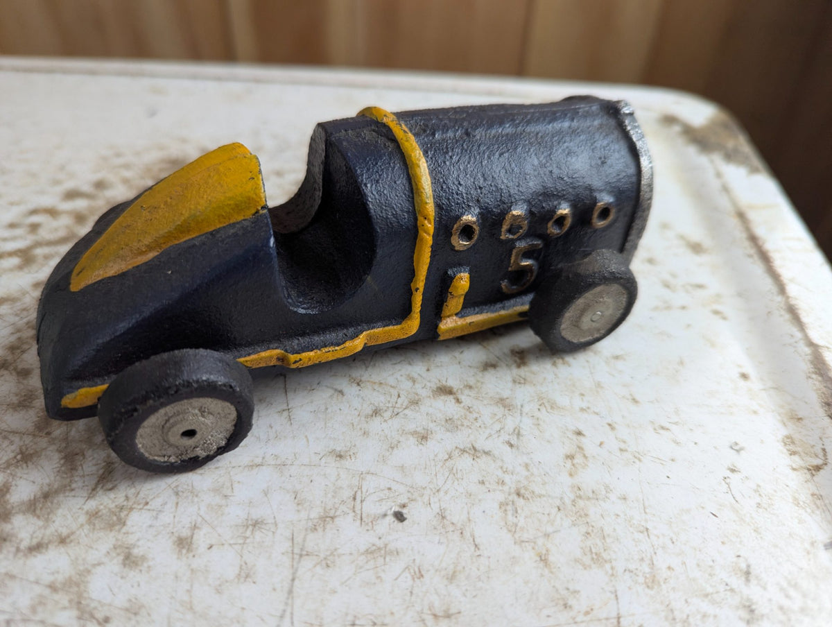 Vintage Cast Iron Race Car Toy with Yellow Stripe - Black