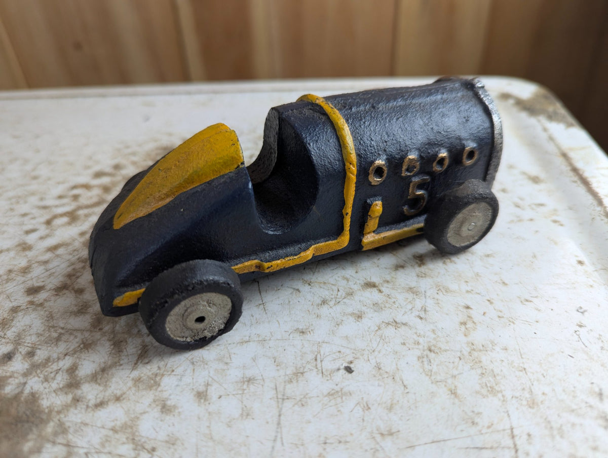 Vintage Cast Iron Race Car Toy with Yellow Stripe - Black