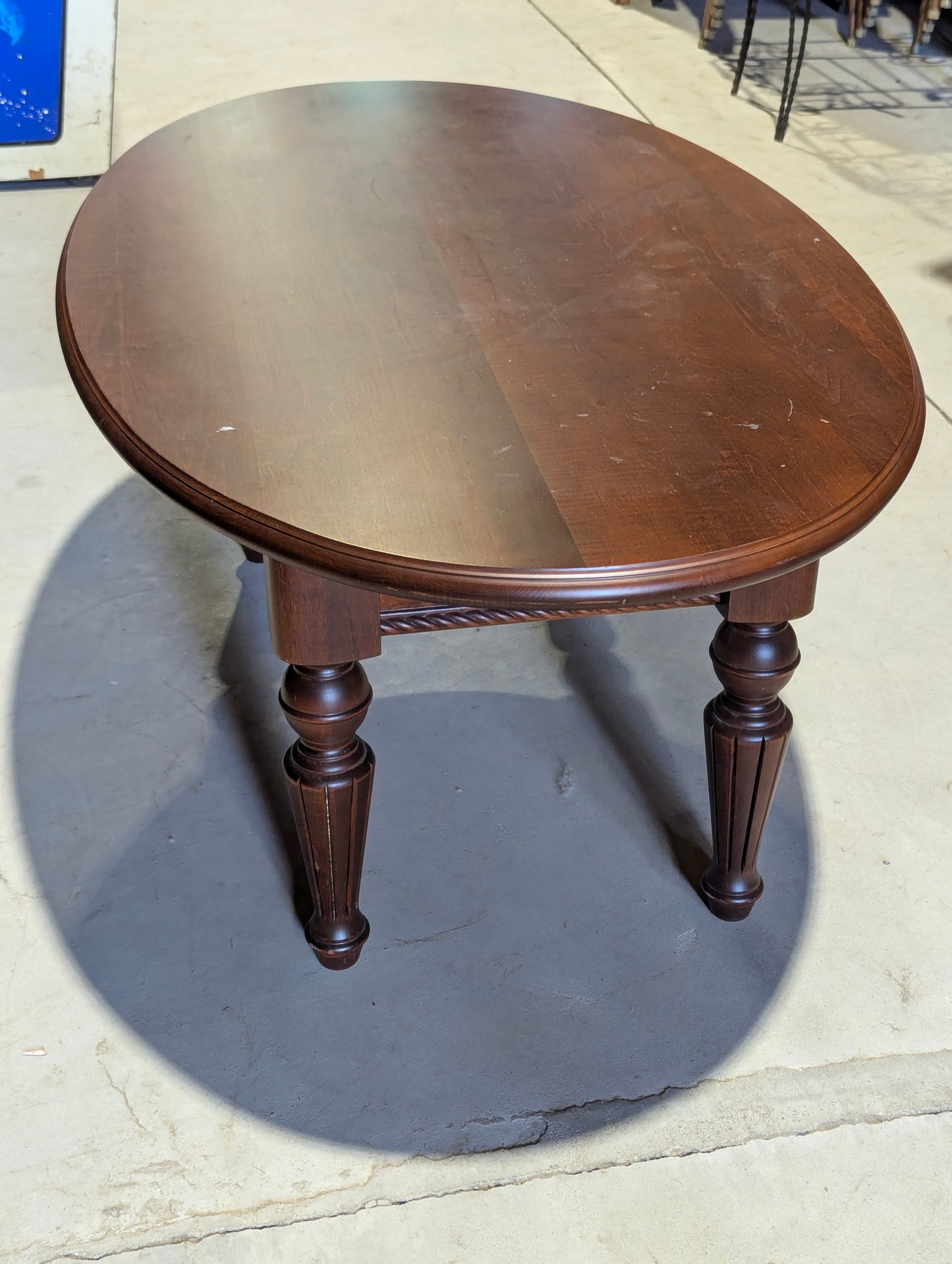 Vintage dark wood oval coffee table with fluted legs
