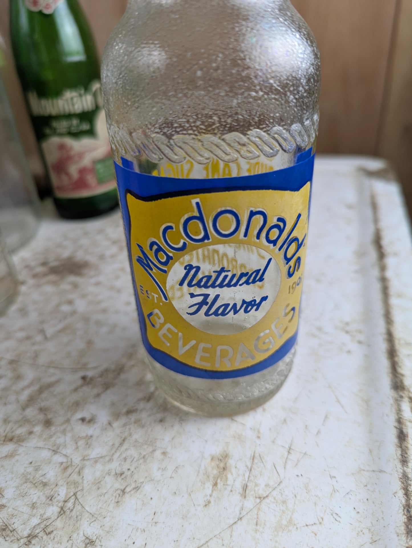 Vintage Macdonald's Beverages Steinie Size Blue and Yellow ACL Soda Bottle - view 2