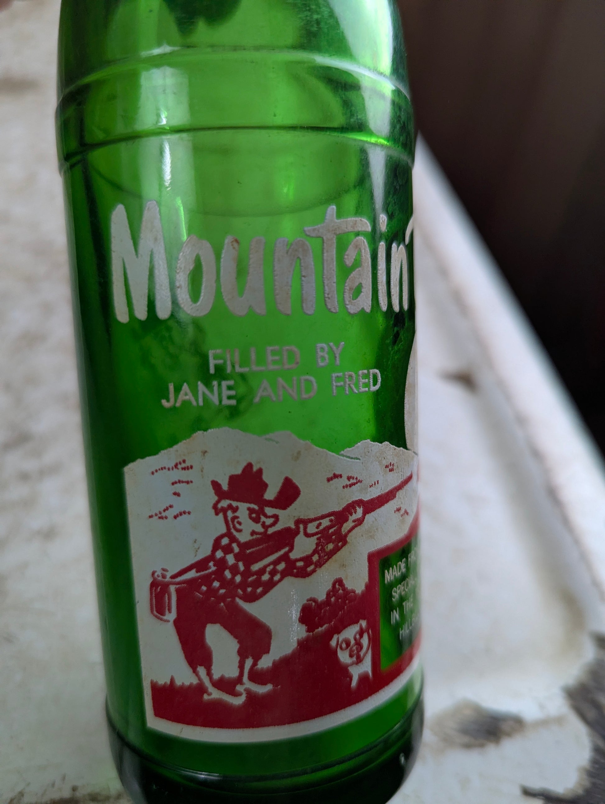 Vintage Mountain Dew 10oz Hillbilly 'Filled by Jane and Fred'  Green Glass ACL Soda Bottle