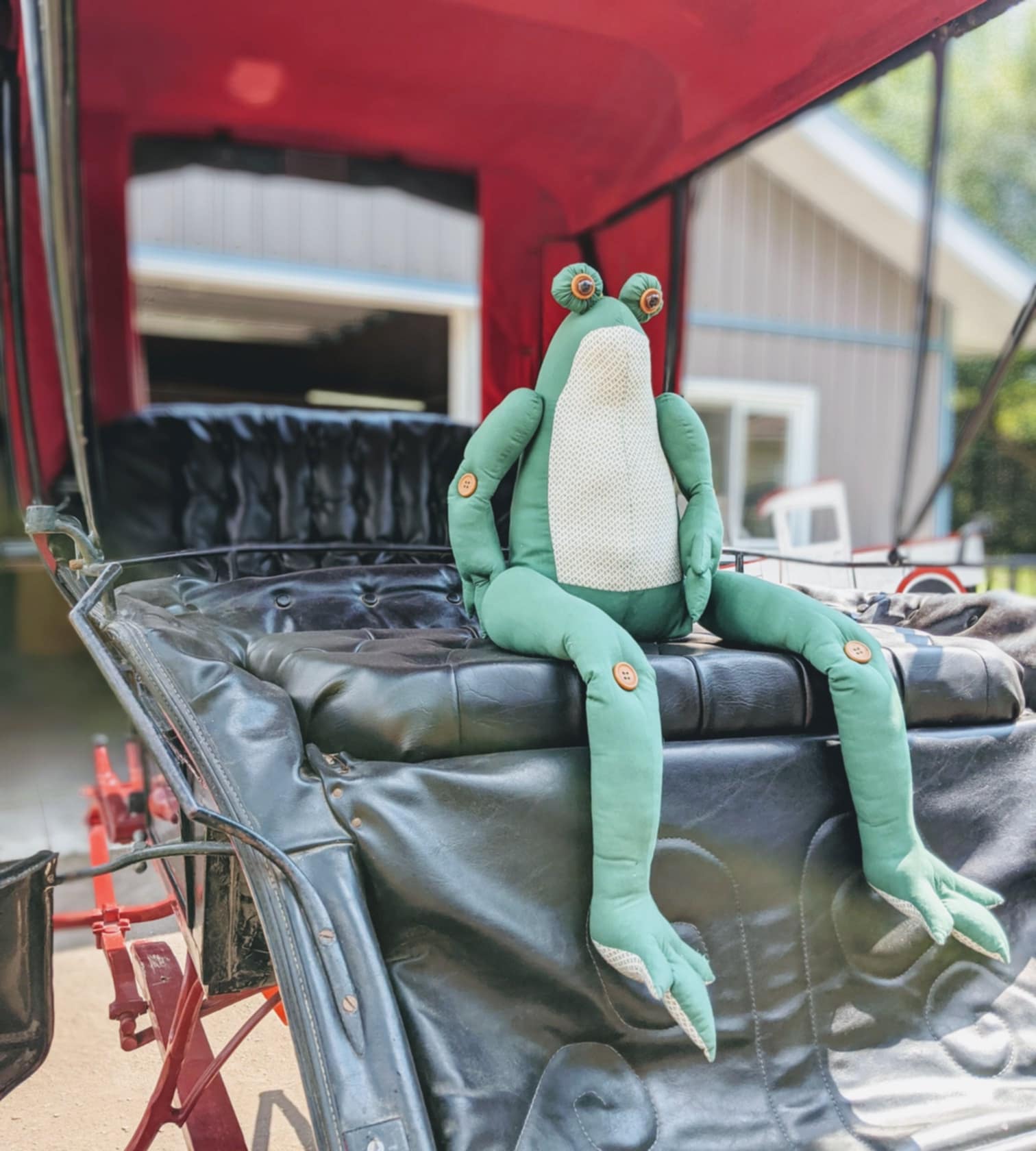 picture of antique buggy with vintage stuffed animal on it